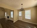 Dining area featuring wood-look floors, bright windows, and modern lighting at 132 Peggy Meadows Way, Douglasville, GA 30134