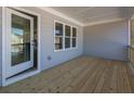 Elegant back porch features wood flooring, white trim, and a glass door entry to the home at 1996 Deco Dr, Kennesaw, GA 30144