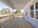 Spacious back porch boasts wood flooring, stylish railings, and views of the yard at 1996 Deco Dr, Kennesaw, GA 30144