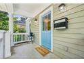Inviting front porch with a light blue door, a 'welcome' mat, and stylish lighting fixtures at 261 Elmira Ne Pl, Atlanta, GA 30307