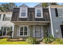 Inviting townhouse with a manicured front lawn, shuttered windows, and a classic, welcoming entrance at 5575 Wells Circle, Stone Mountain, GA 30087