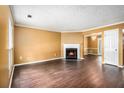 Comfortable living room showcasing a cozy fireplace, rich flooring, and a bright, inviting atmosphere at 5575 Wells Circle, Stone Mountain, GA 30087