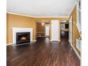 Spacious living room features beautiful hardwood floors, fireplace, and open layout to dining area and kitchen at 5575 Wells Circle, Stone Mountain, GA 30087