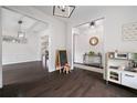 Open living area featuring hardwood floors, modern lighting, and access to multiple rooms at 1998 Lakeview Bend Way, Buford, GA 30519
