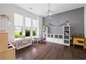 Spacious playroom with large windows, custom storage, and durable hardwood floors at 1998 Lakeview Bend Way, Buford, GA 30519