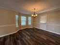 Bright dining area with hardwood floors, large windows, and a modern chandelier at 296 Hayes Trce, Hiram, GA 30141