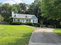 Attractive home with a long driveway, lush lawn, and mature trees, creating a private setting at 296 Hayes Trce, Hiram, GA 30141
