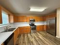 Well-lit kitchen featuring stainless steel appliances, ample counter space, and wood cabinets at 296 Hayes Trce, Hiram, GA 30141