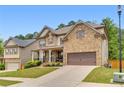 Charming brick home with a two-car garage and neatly landscaped front yard at 406 Fernstone Dr, Canton, GA 30114