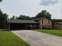 Inviting two-story home with a long driveway and lush green lawn, perfect for Gathering living at 2104 Moon Sw Dr, Conyers, GA 30094