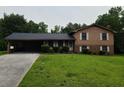 Charming two-story home with a covered carport and well-maintained lawn at 2104 Moon Sw Dr, Conyers, GA 30094
