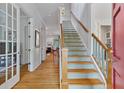 Bright foyer with hardwood floors, staircase, and view into adjacent rooms at 453 Carter Se Ave, Atlanta, GA 30317