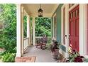 Inviting front porch with a rocking chair and decorative plants by a red front door at 453 Carter Se Ave, Atlanta, GA 30317