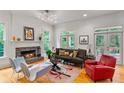 Bright living room with a stone fireplace, hardwood floors, and French doors leading to a deck at 453 Carter Se Ave, Atlanta, GA 30317