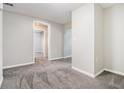 Hallway with neutral walls, and soft gray carpeting at 211 Margaret St, Fairburn, GA 30213