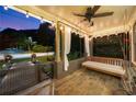 Evening view of inviting front porch with slate flooring, a porch swing, string lights, and a ceiling fan at 486 Haas Se Ave, Atlanta, GA 30316