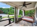 Inviting front porch with slate flooring, a porch swing, string lights, and a ceiling fan at 486 Haas Se Ave, Atlanta, GA 30316