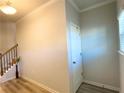 Bright foyer view with staircase and nearby door showcasing neutral tones at 2757 Malton Way, Loganville, GA 30052
