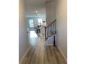 Open-concept layout with light wood floors from foyer flowing into living and dining areas at 2757 Malton Way, Loganville, GA 30052