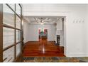 Elegant entryway featuring hardwood floors, detailed trim, fireplace, and an open view to the kitchen at 2855 Middlecreek Way # 2855, Cumming, GA 30041