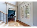 Elegant foyer with double doors and a view into the music room with a grand piano at 652 Pathview Ct, Dacula, GA 30019