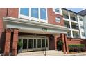 Building entrance featuring brick columns, decorative molding, and elegant glass doors at 3275 Lenox Ne Rd # 110, Atlanta, GA 30324
