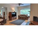 Inviting living room featuring hardwood floors, ceiling fan, and a large window offering ample natural light at 3275 Lenox Ne Rd # 110, Atlanta, GA 30324
