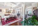 Elegant dining room featuring coffered ceilings, hardwood floors, and open access to the living areas at 466 Sweet Apple Ln, Buford, GA 30518