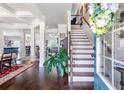 Inviting foyer with hardwood floors, staircase, and views into the adjacent dining and living areas at 466 Sweet Apple Ln, Buford, GA 30518