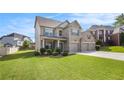 Beautiful brick home with a three-car garage, well-maintained landscaping, and a spacious driveway at 4854 Cathedral Ct, Powder Springs, GA 30127