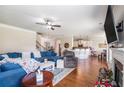 Comfortable living room with hardwood floors, ceiling fan, and a view of the kitchen at 4854 Cathedral Ct, Powder Springs, GA 30127