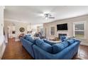 Inviting living room features a plush blue sofa, fireplace, and abundant natural light at 4854 Cathedral Ct, Powder Springs, GA 30127