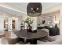 Stylish dining area featuring a modern light fixture, round table, and tasteful wall art at 5430 Hyde Rd, Cumming, GA 30040