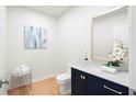 Stylish half bathroom featuring modern fixtures, elegant mirror, and sophisticated color palette at 860 Crest Valley Dr, Sandy Springs, GA 30327