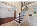 Inviting foyer featuring a staircase with iron balusters and hardwood floors, with a dining room to the left at 125 Ancient Oak Ln, Stockbridge, GA 30281