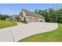Spacious garage with ample parking and lush green lawn at 131 Forsyth Park Ln, Woodstock, GA 30188
