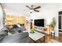 Bright, open-concept living area with modern decor, hardwood floors, and a cozy sectional sofa at 1744 Blossom Ln, Austell, GA 30168