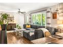 Comfortable living space featuring hardwood floors, gray sectional sofa, and lots of natural light at 1744 Blossom Ln, Austell, GA 30168