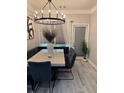 Bright dining room features a modern chandelier, seating bench, and sleek table with stylish chairs at 2535 Village Creek Lndg, Atlanta, GA 30316