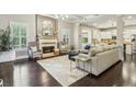 Open-concept living room with hardwood floors, a cozy fireplace, and an abundance of natural light at 2579 Lulworth Ln, Marietta, GA 30062