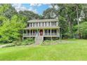 Charming two-story home with a welcoming front porch and a well-manicured lawn with mature landscaping at 2816 Highland Park Dr, Stone Mountain, GA 30087