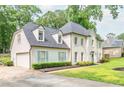 Charming two-story home with a two car garage, light green shutters, and landscaped front yard at 2735 Jims Ne Rd, Marietta, GA 30066