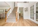 Inviting foyer with hardwood floors, staircase, and elegant sconces at 2735 Jims Ne Rd, Marietta, GA 30066