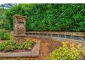 Stone Windsor Oaks community sign surrounded by lush greenery and colorful flowers at 2735 Jims Ne Rd, Marietta, GA 30066