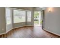Bright living room with hardwood floors, large windows and view of the front yard at 5920 Hampton Ct, College Park, GA 30349