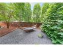 Relaxing backyard haven featuring a comfortable hammock, gravel area, and verdant foliage for ultimate tranquility at 1267 Thomas Rd, Decatur, GA 30030