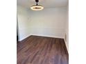Simple dining room featuring hardwood floor and a modern ceiling fan at 311 Indus Ln, Lawrenceville, GA 30044