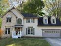Charming two-story home featuring a brick accent, a covered entryway, and an attached two-car garage at 311 Indus Ln, Lawrenceville, GA 30044