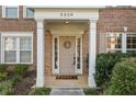 Inviting front entrance with classic door, decorative wreath, and white column supports at 3328 Chastain Gardens Nw Dr, Kennesaw, GA 30144