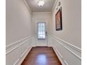 Elegant hallway with hardwood floors, wainscoting, and a rear entry door at 5016 Garrett Ct, Alpharetta, GA 30005